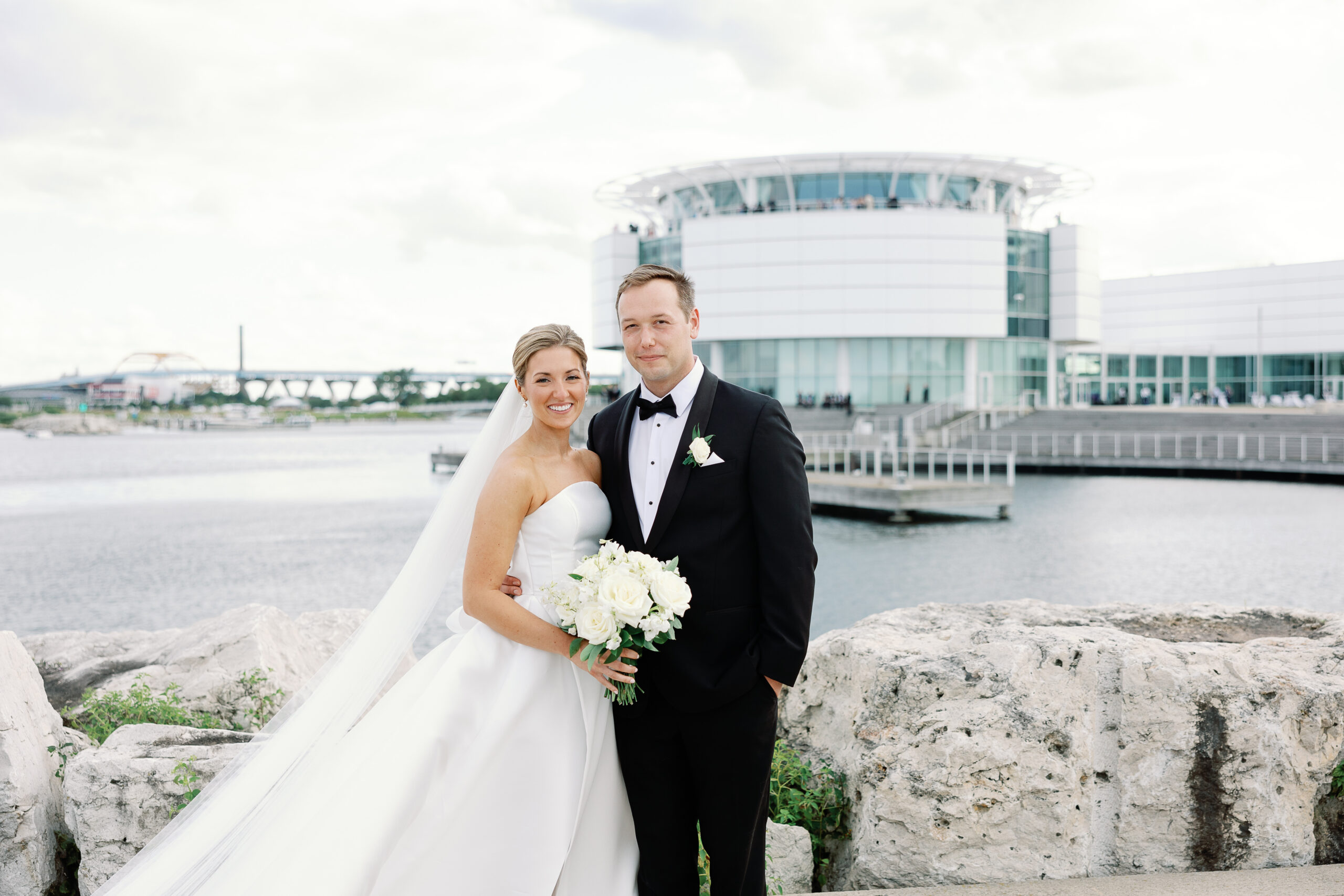 Bride and groom portrait in front of Discovery World on Milwaukee's lakefront.